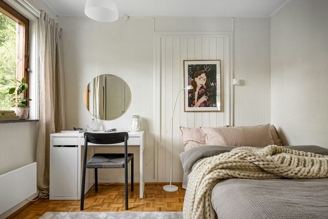Small bedroom with a bed beneath a window, a desk and a mirror