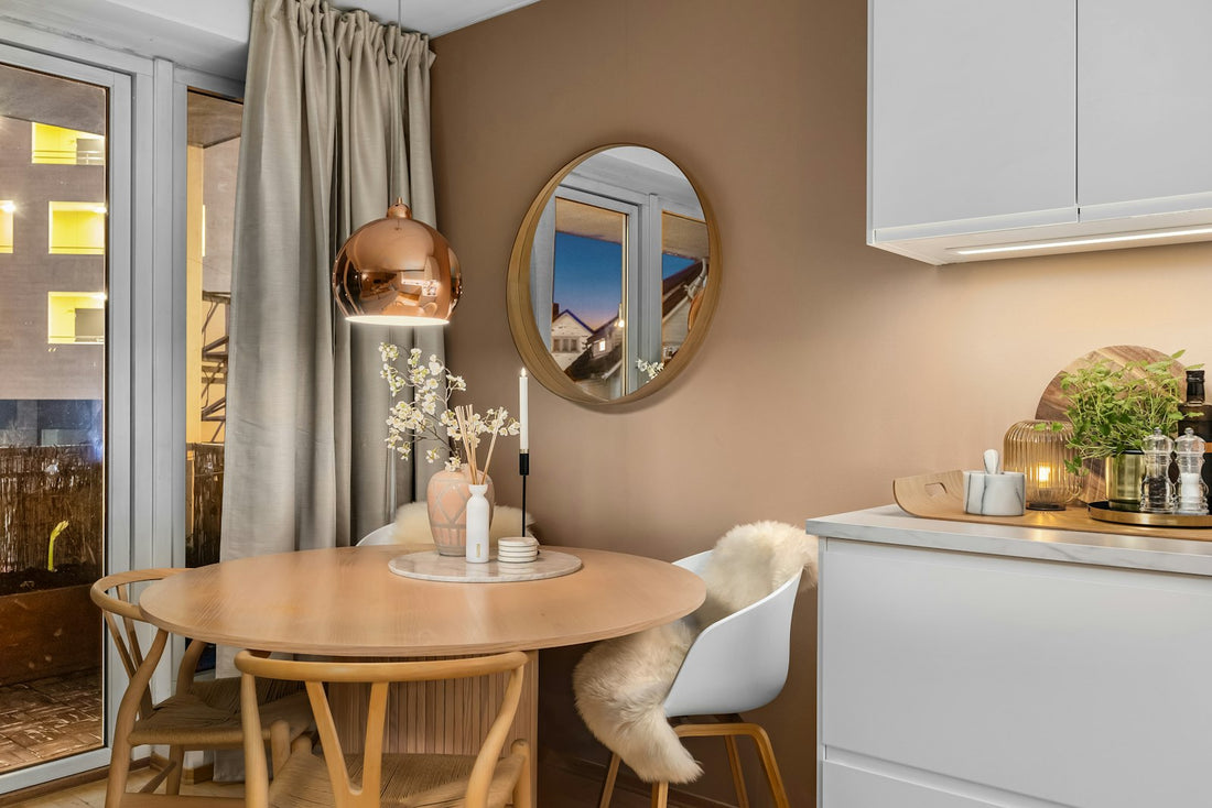 Small apartment kitchen with a table and chairs by a bright window