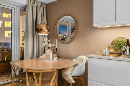 Small apartment kitchen with a table and chairs by a bright window